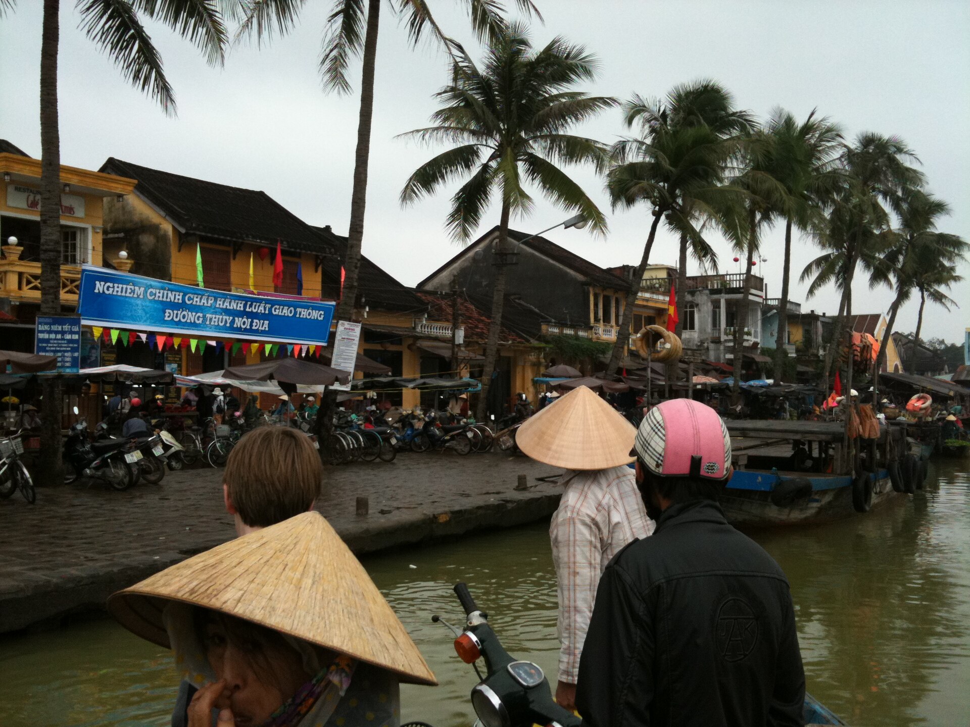 A ferryboat approaches the riverbank in Hoi An's Old Town.